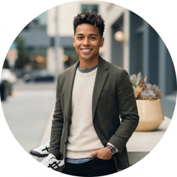 Circular portrait of Alex Rivera wearing casual attire and Anjrs running shoes in a bright, modern studio setting.
